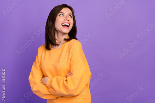 Close up photo pretty adorable lady wear trendy clothes arm folded empty space banner good mood isolated on purple color background © deagreez