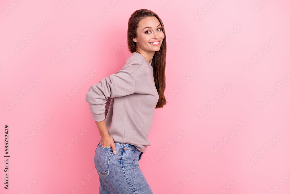 Profile portrait of satisfied glad lady put hands pockets beaming smile isolated on pink color background Profile portrait of satisfied glad lady put hands pockets beaming smile isolated on pink color background