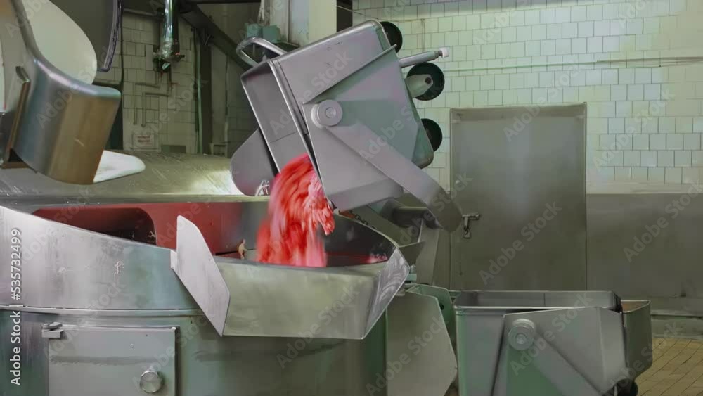 Chopped pieces of meat are added to large blender mixer for minced meat production