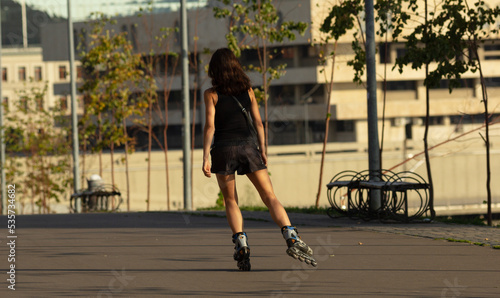 a young girl is doing sports roller skating on the street