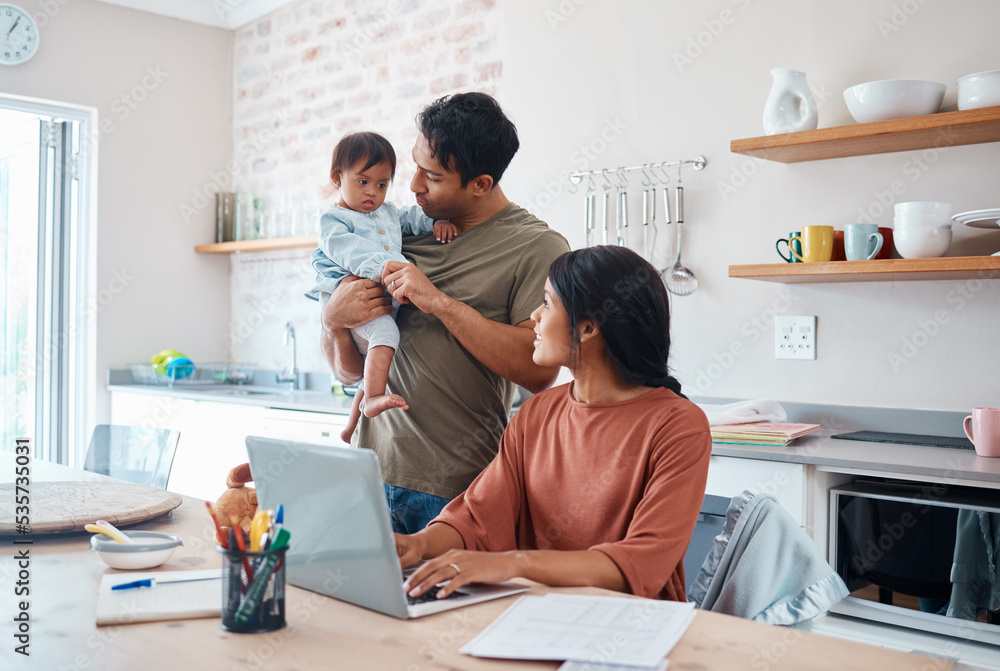 Obraz premium Family, baby and down syndrome while mother work online with laptop in kitchen. Mom, father and child play while mother use computer for learning, education or college on the internet in house