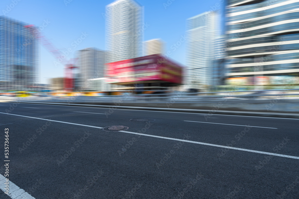 empty asphalt road with city skyline background in china empty asphalt road with city skyline background in china