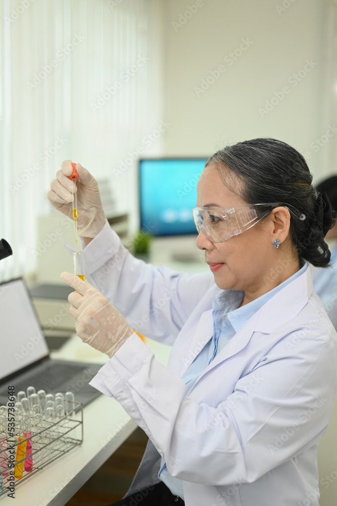 Professional scientists team conducting experiment in modern laboratory. Medicine and science researching concept Professional scientists team conducting experiment in modern laboratory. Medicine and science researching concept