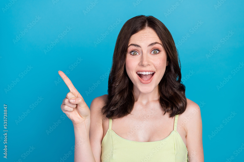 Photo of impressed crazy person open mouth indicate finger empty space blank isolated on blue color background Photo of impressed crazy person open mouth indicate finger empty space blank isolated on blue color background
