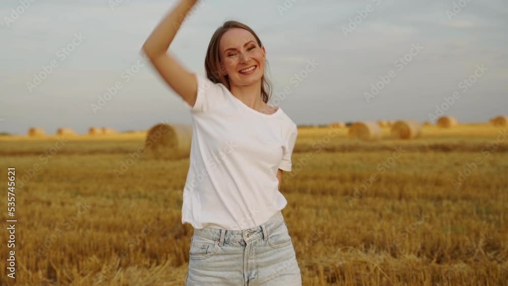 Gorgeous woman in a wheat field against the sunset. Fashionable girl with long hair rejoices, laughs. Gorgeous woman in a wheat field against the sunset. Fashionable girl with long hair rejoices, laughs.