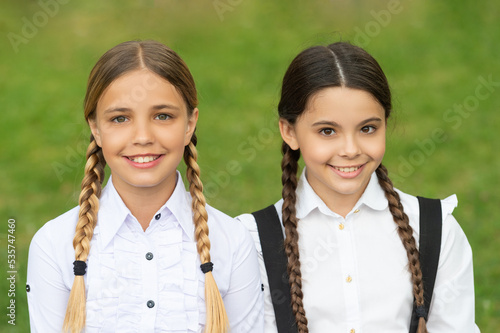 schoolgirl portrait. two positive teen children schoolgirls outdoor. friendship of schoolgirls © be free