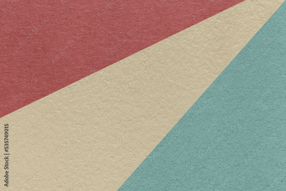 Fototapeta premium Texture of old craft beige, blue and maroon color paper background, macro. Vintage abstract cerulean cardboard.