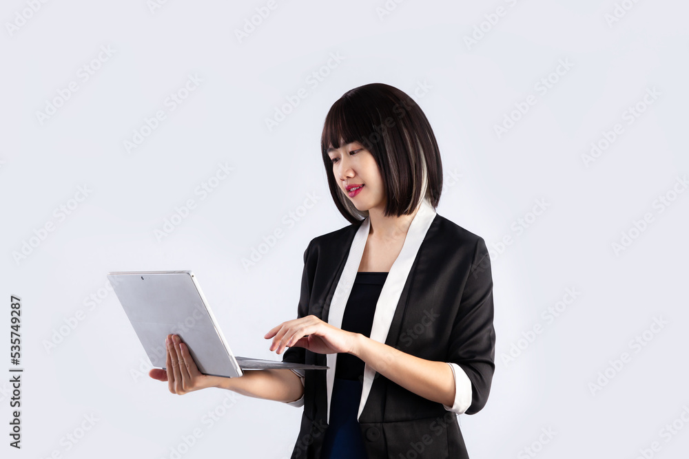 Asian Businesswoman short hair style using laptop on white background. Asian Businesswoman short hair style using laptop on white background.