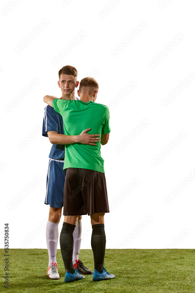 Congrats on the victory. Rival soccer players in action, motion isolated over white background. Sport, competition, communication and match concept.