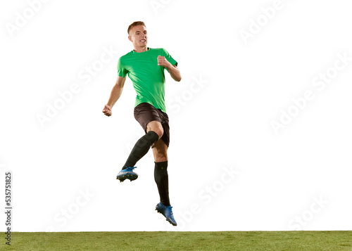 One young man, professional soccer football player jumping isolated on white studio background. Concept of action, energy, sport. © master1305