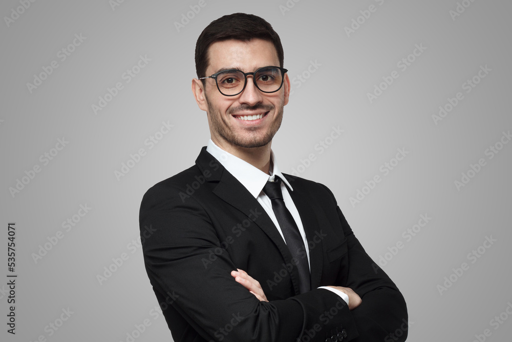 Positive businessman in black suit, white shirt, tie, glasses with arms crossed, ready to cooperate Positive businessman in black suit, white shirt, tie, glasses with arms crossed, ready to cooperate