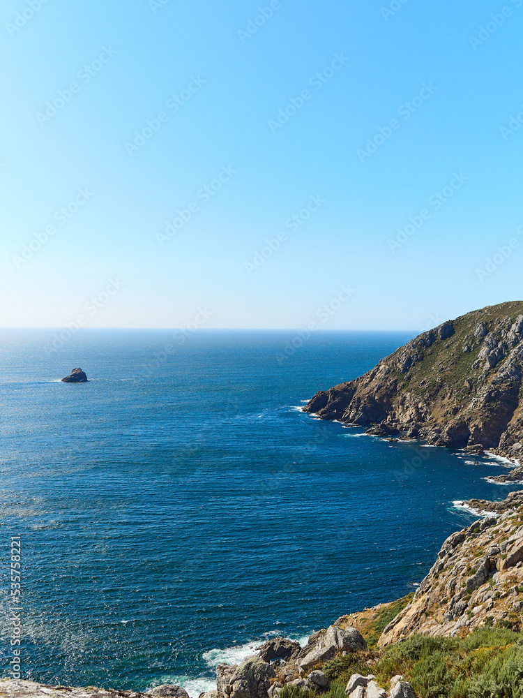 Galician coast, cliffs with the water hitting the rocks, vertical view