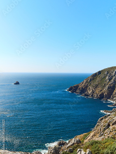Galician coast, cliffs with the water hitting the rocks, vertical view © IGIA TEAM