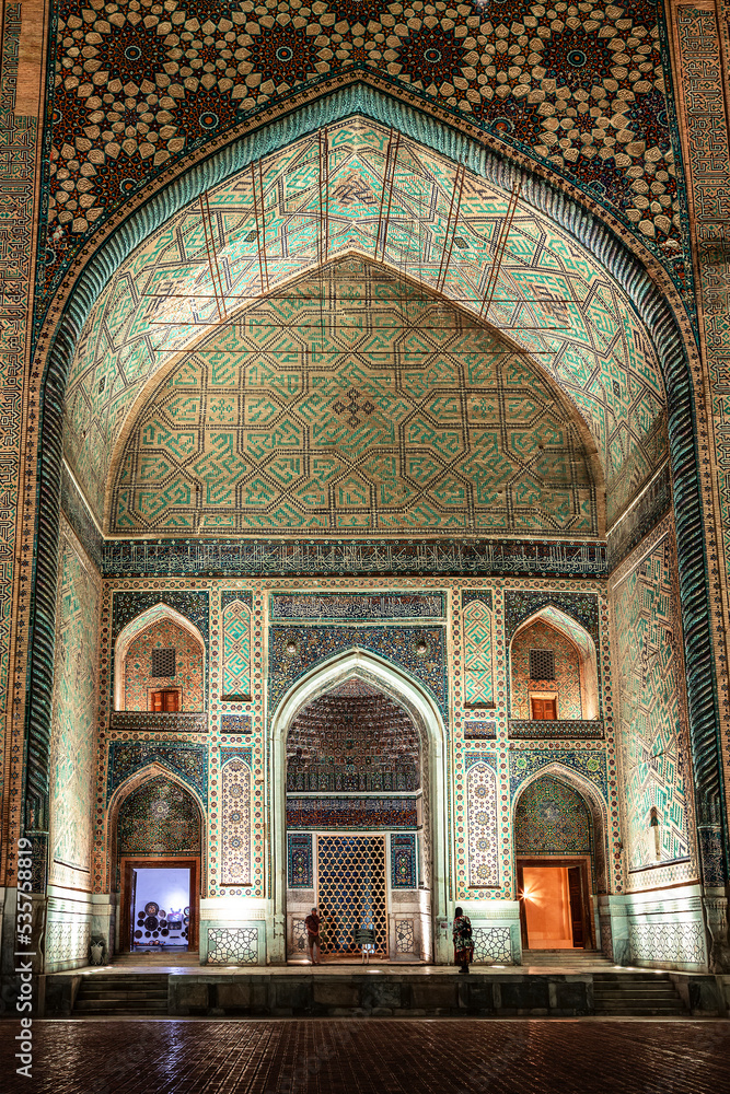 Facade (portal) of Ulugbek Madrasah from Registan Square with night lighting. Samarkand, Uzbekistan
