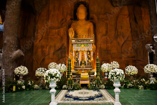 Carving stone and sculpture rock buddha image statue on stone wall for thai people travel visit respect praying blessing worship in Wat Maniwong temple on September 6, 2022 in Nakhon Nayok, Thailan photo