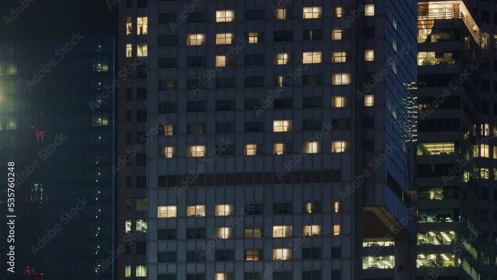 Time lapse day to night transition blinking windows lights in business and high residential building in downtown. Corporate business, skyscraper glass surface. Light in building windows turn on Time lapse day to night transition blinking windows lights in business and high residential building in downtown. Corporate business, skyscraper glass surface. Light in building windows turn on