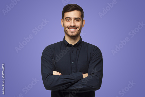 Smiling attractive business man in shirt isolated on purple background