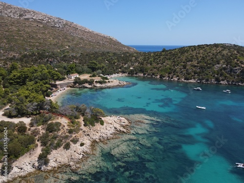 Aerial view of Cala Moresca and Figarolo Island in Golfo Aranci, north Sardinia. Birds eye from above of yacht, boats, crystalline and turquoise water. Tavolara Island in the background, Sardegna. © AerialDronePics