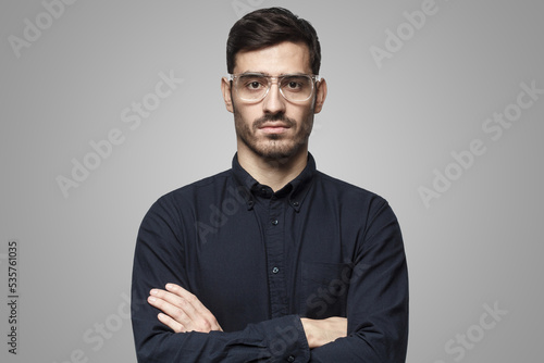 Serious confident businessman isolated on gray