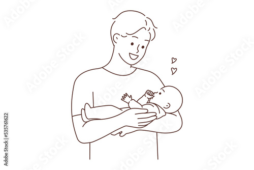 Happy father holding baby in arms 
