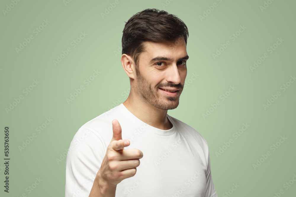 Caucasian male pointing at camera on green background Caucasian male pointing at camera on green background