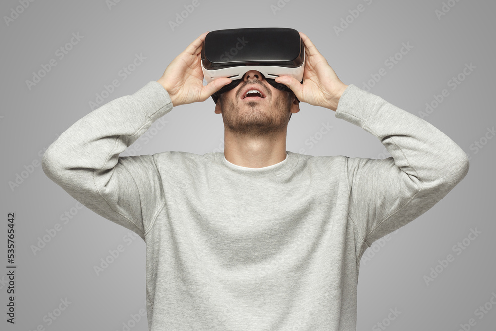 European man experiencing virtual reality through headset European man experiencing virtual reality through headset