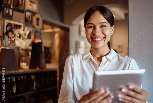 Tablet, management and coffee shop with a woman small business owner or entrepreneur working in her cafe. Portrait, vision and technology with a female employee using the internet in her restaurant