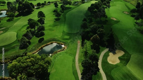 Aerial drone forward moving shot over a green golf club in Northbrook Illinois, USA at daytime. photo