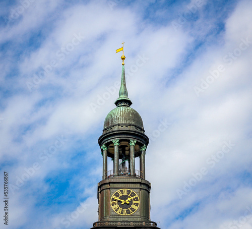 The tower of St Michaels church (Hauptkirche Sankt Michaelis) with people on the viewing platform on a bright summer day with blue sky photo