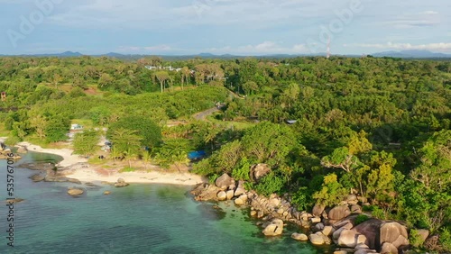 rocky tropical coastline on Belitung Island in Indonesia at golden hour sunset, aerial