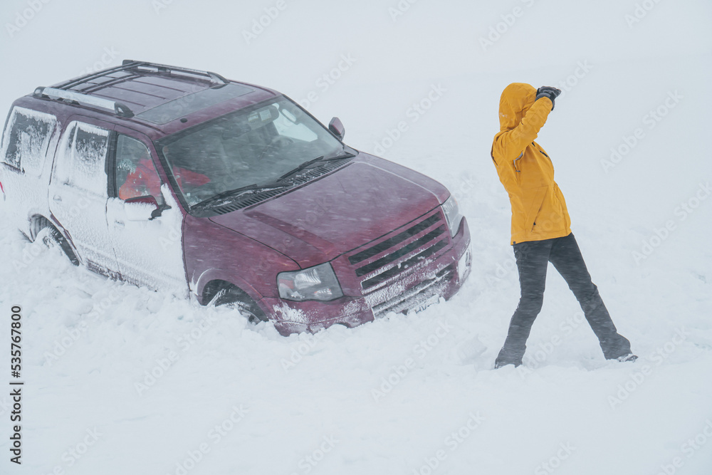 Woman gets out of the car to seek help after a traffic accident.