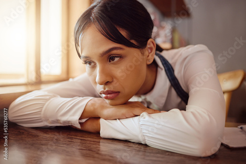 Sad waiter in Paris cafe, woman tired at table in bistro and hospitality service industry job. Disappointed face in small business, bored fatigue at restaurant and mental health depression at work