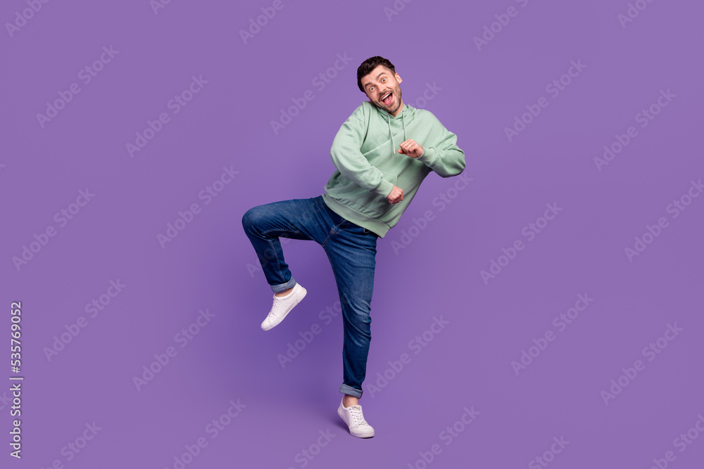 Full body size photo of young excited positive cute man dancing party event hands movement chill carefree hobby isolated on violet color background Full body size photo of young excited positive cute man dancing party event hands movement chill carefree hobby isolated on violet color background