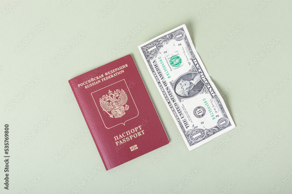 Russian foreign passport and one dollar on green background. Currency exchange Russian foreign passport and one dollar on green background. Currency exchange