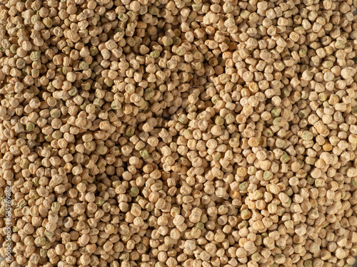 Background of the pea texture from the top view. The texture of a natural food background from pea seeds. Close-up of the surface of a large number of dry pea grains with texture