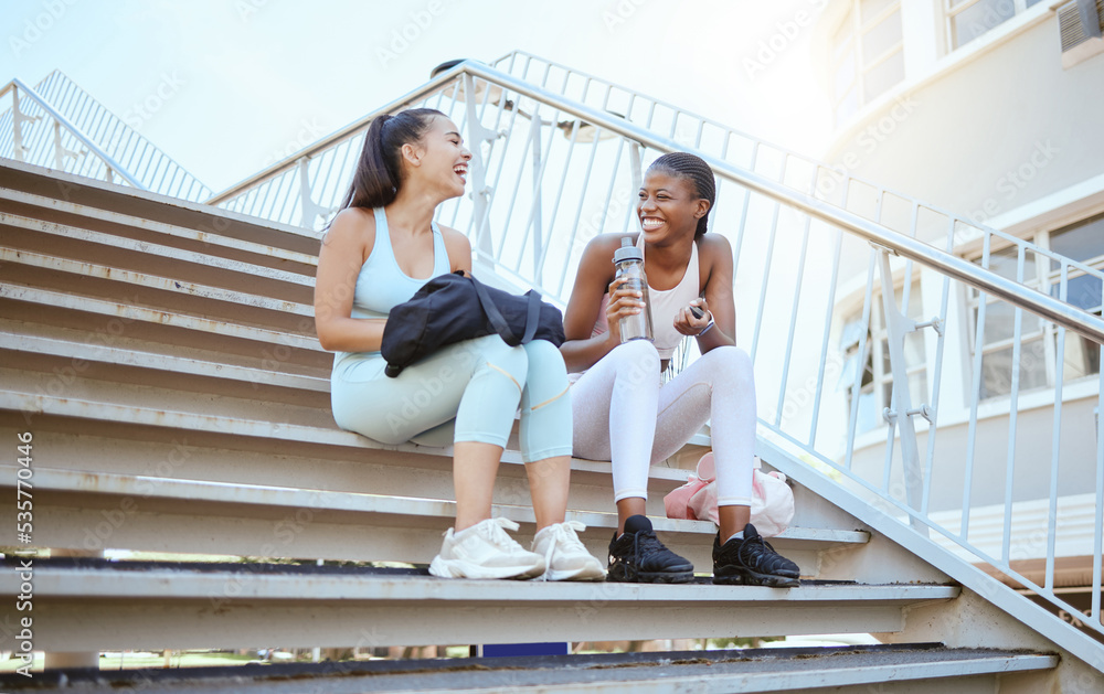 City fitness, relax and friends on stairs after running for cardio with water together in Australia. African runner women with smile, laughing and happy after outdoor workout and exercise training City fitness, relax and friends on stairs after running for cardio with water together in Australia. African runner women with smile, laughing and happy after outdoor workout and exercise training
