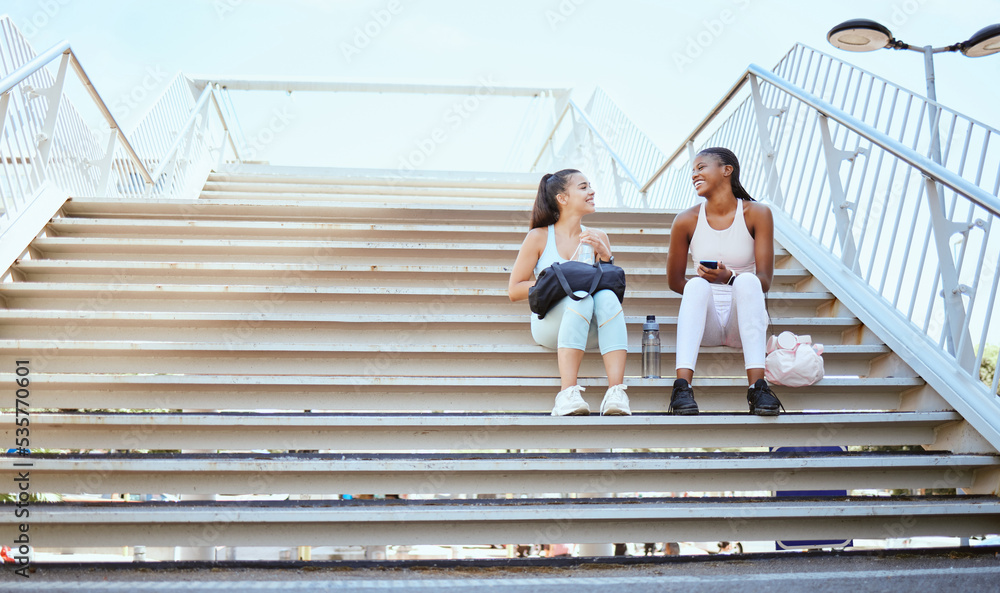 Friends, happy and relax after exercise on steps together, talking and bonding after morning cardio outdoors. Smiling, cheerful and females resting on stairs, enjoying free time after workout in city