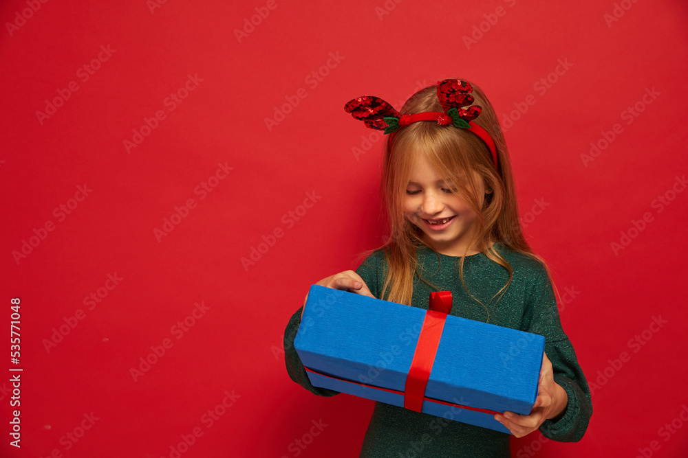 Smiling funny child (kid, girl) in Reindeer Hairband Smiling funny child (kid, girl) in Reindeer Hairband