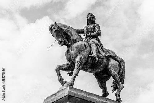 Equestrian statue of Joan of Arc (Jeanne d'Arc) in Orleans, France  bronze outdoor monument in black and white © PhotoFires