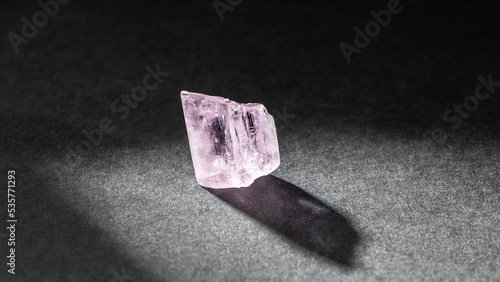 Kunzite crystal healing stone on black background photo