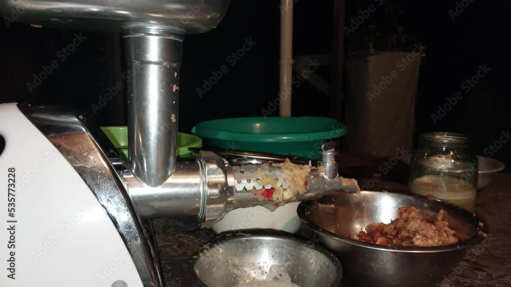 Squeezing apple juice on a screw juicer Squeezing apple juice on a screw juicer