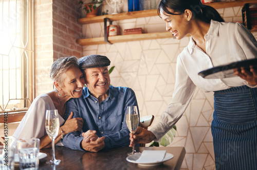 Love  couple elderly and celebrate marriage with date and wine at restaurant  happy  smile or relax together. Loving  senior man and woman with champagne for celebration of retirement or anniversary