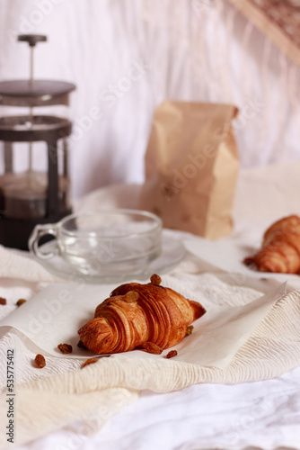 Vertical shot of a simple french breakfast of croissants and coffee prepared in a french coffee press