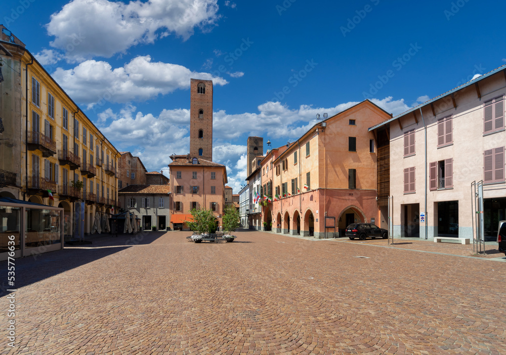 Alba, Langhe, Piedmont, Italy - August 16, 2022: Piazza Risorgimento historic center of the city with the town hall, the arcades and the medieval towers of the age of the communes