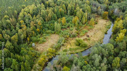 forest and river at sunset in autumn. Aerial view of wildlife in Latvia, Europe