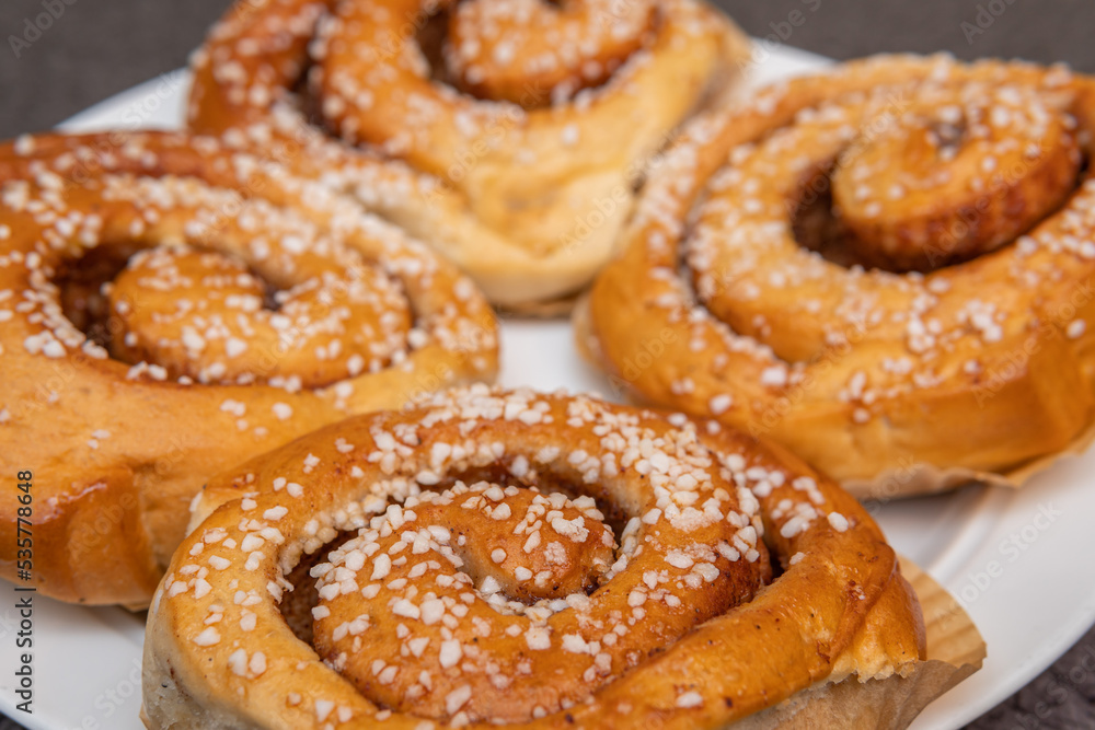Many tasty cinnabons buns (kanelbullar) with sugar filling, swedish specialty