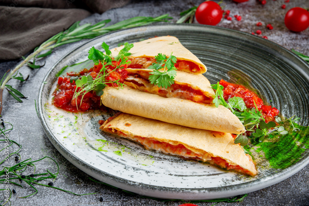 Pita bread with chicken and cheese filling. Pancakes with tomato filling