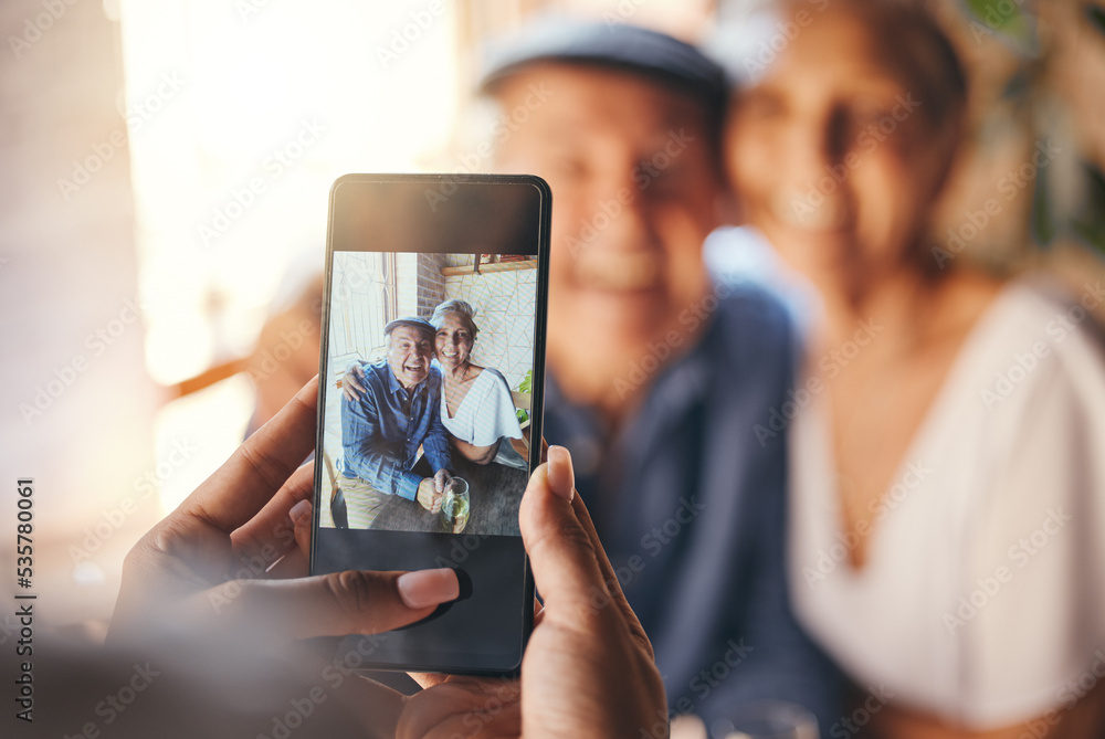 Pov, phone and woman taking picture of old couple at restaurant. Love, smile and elderly, romantic and retired couple hug with person taking photo for happy memories, 5g mobile or social media post.