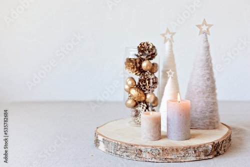 Christmas table decoration with candles and handmade minimalist christmas trees. Festive interior design, easy and cheap diy centerpiece idea. photo