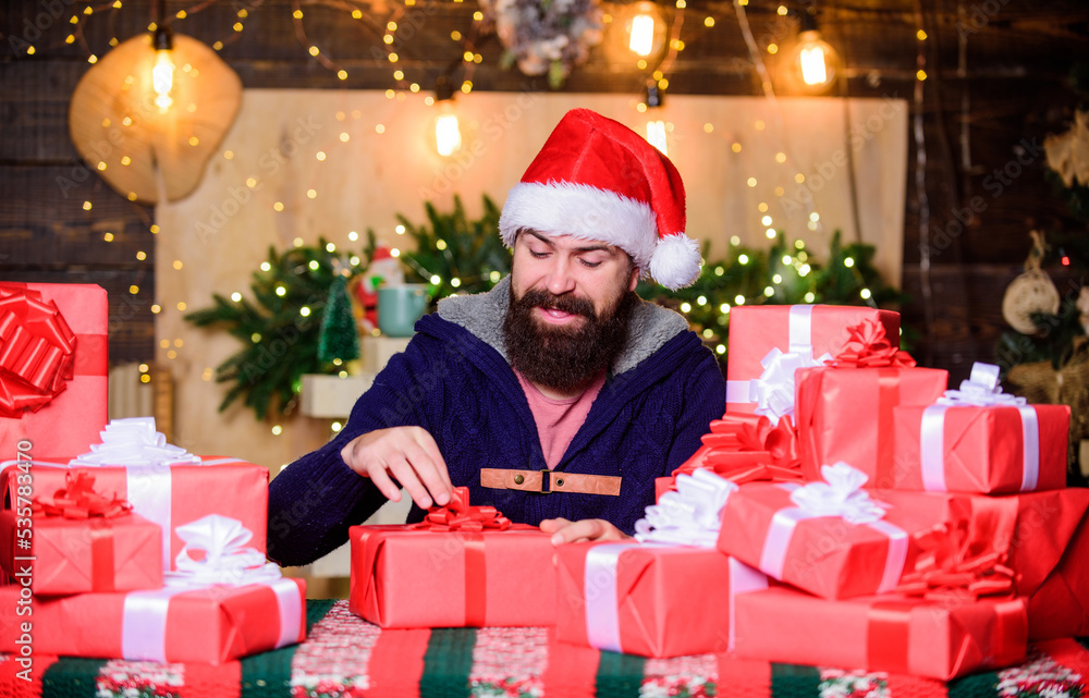 interesting what is inside. happy new year. Xmas present box. shopping sales. holiday celebration. hipster santa hat. Christmas shopping. christmas presents delivery. Boxing day. happy bearded man